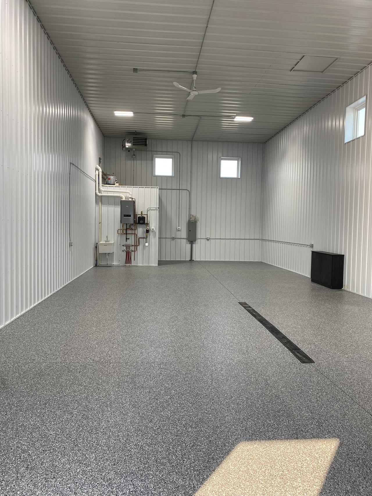 inside view of shop number 9!  This unit offers indoor heating and custom floor coating with a bathroom in the rear of the space.