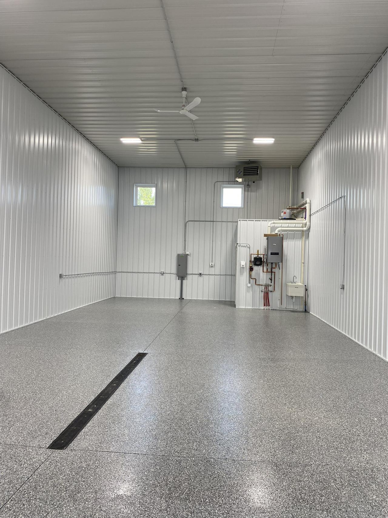 A view of shop unit 10! This unit offers indoor heating and custom floor coating with a restroom in the rear of the space.